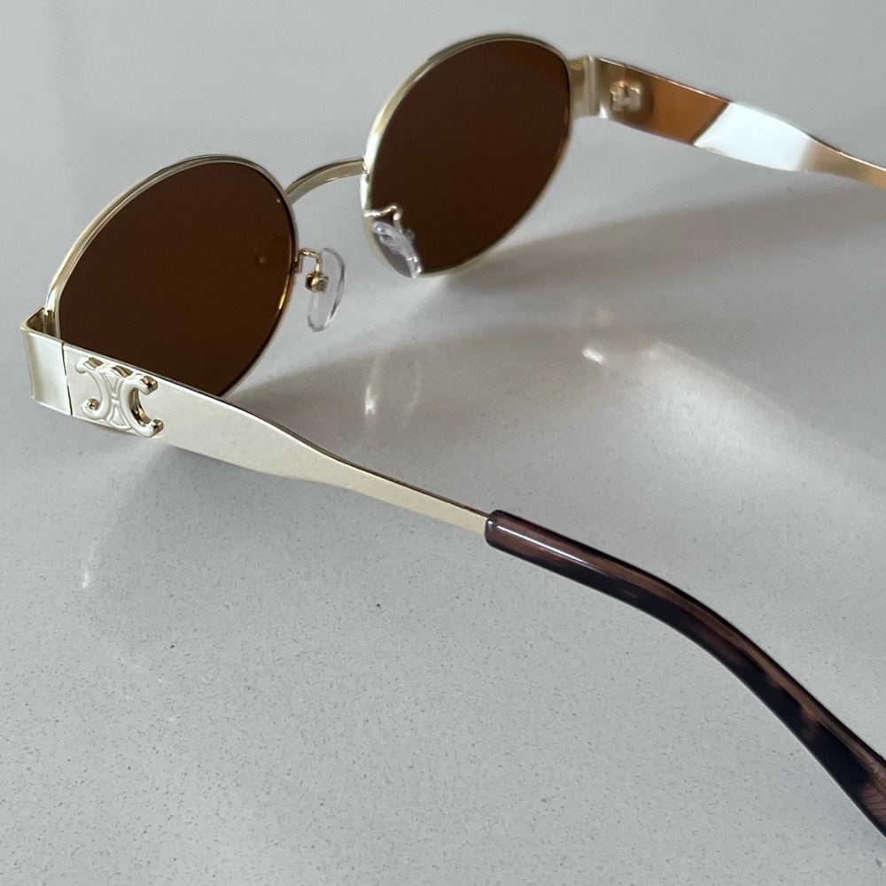 Chic Black and Gold Oval Sunglasses with Metal Frames - Picture 7 of 9